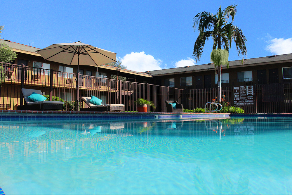 This image displays swimming pool photo of Ambassador Inn Apartments